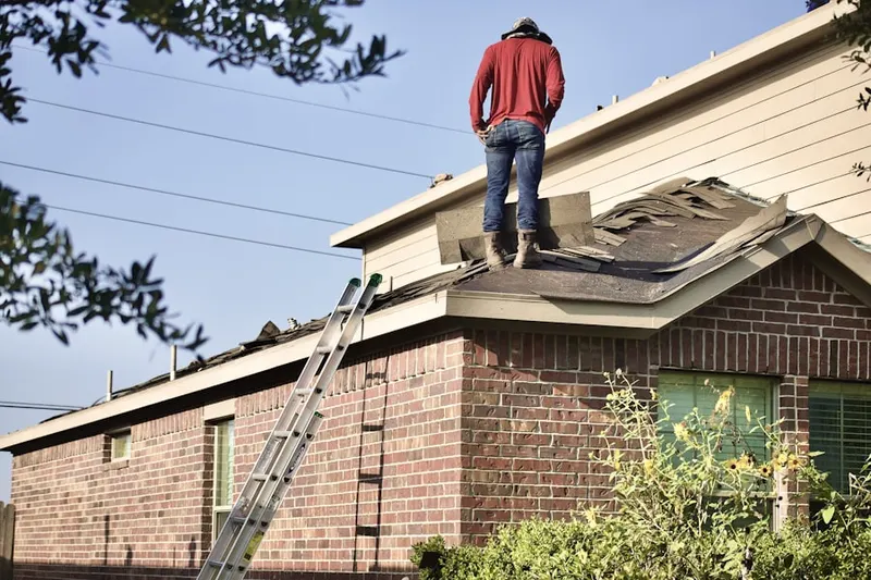 Professional roofer working on a residential roof in North Weymouth